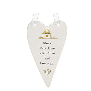This lovely heart shaped, ceramic plaque from Thoughtful Words Ceramics brings a blessing to the home - ideal for a new home present. This white glazed heart is decorated with a tiny gold house above black stamped text that reads "Bless this home with love and laughter".
