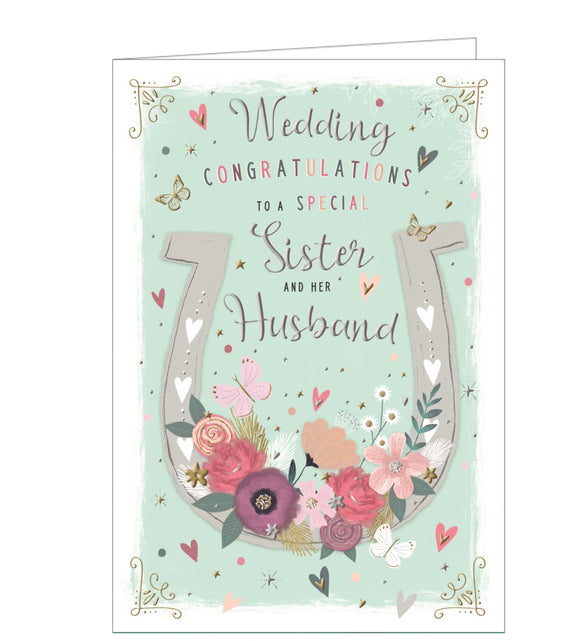This wedding card for a special sister and brother-in-law is decorated a large white horseshoe, adorned with flowers and butterflies. Silver text on the front of the card reads 