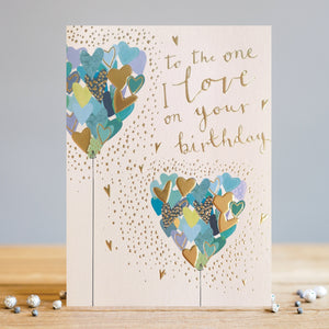 This elegant birthday card for someone very special is decorated with two stylised heart-shaped balloons - actually made up of lots of tiny blue, green and gold hearts. A sprinkling of golden confetti surrounds the balloons and makes the card sparkle. Gold text on the front of the card reads "to the One I Love on your Birthday".