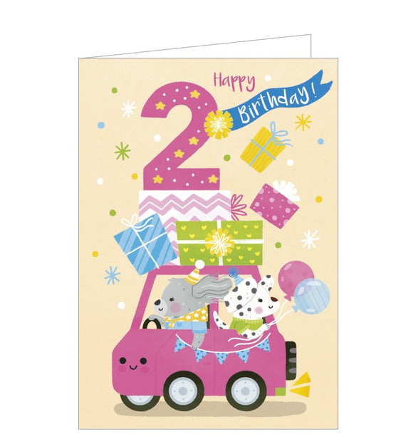 A bright, lively birthday card for a 2 year old is decorated with a cartoon of two dogs driving a pink car loaded with presents. The text on the front of the card reads 