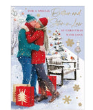 Celebrate the holidays with this beautiful Christmas card for a special brother and sister in law. Featuring a cozy couple kissing in the snow, this card is complete with festive touches, presents, a robin, and Christmas decorations. Share the joy and love with this heartwarming card.