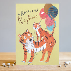 Send your favorite nephew a special birthday card with this wonderful Louise Tiler greetings card. This card is decorated with an adult tiger carrying a youngster on its back and holding a bunch of colourful balloons under its paws. The caption on the front of the card reads "a Roarsome Nephew".