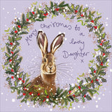 Part of Alex Clark's Christmas card collection, this Christmas card is decorated with Alex's painting of a hare looking out through a festive wreath, against a lilac background. The text on the front of the card reads "Merry Christmas to a lovely Daughter x".