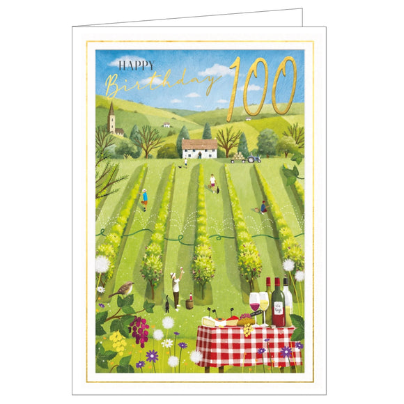 This lovely 100th birthday card is decorated with a scene of a sunny vineyard with a table in the foreground, laid with cheese and wine. Golden text on the front of the card reads 