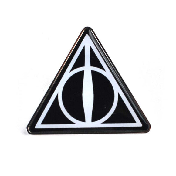 This enamel pin badge has a black background and is decorated with the symbol for the Deathly Hallows comprised of a triangle for the cloak of invisibility, a circle for the resurrection stone, and a line for the elder wand.