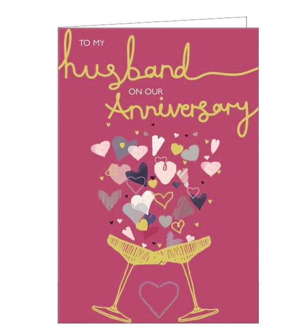 This anniversary card for a special husband is decorated with two gold metallic champagne coupes clinking together and overflowing with metallic and glittery hearts. The text on the front of the card reads 