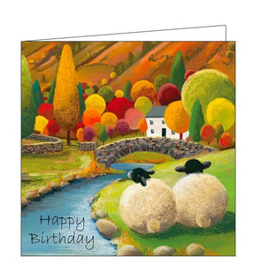 This birthday card features detail from an original pastel drawing by Lucy Pittaway showing two sheep sitting together by a stream, looking towards a bridge and a little white house surrounded by red, gold and green trees. Text in the front of the card reads "Happy Birthday".