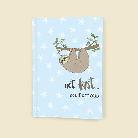 This this softbacked A6 lined notebook is decorated with a cute sloth hanging  from a tree branch. The caption on the front of the note book reads 