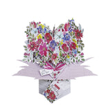 This beautiful pop-up birthday card opens up to reveal a 3d heart of pink and purple glittery flowers. Text on the front of the card reads "Just for you...on your Birthday". The card comes complete with an attached tag and a space on the back of the card for your own messages.