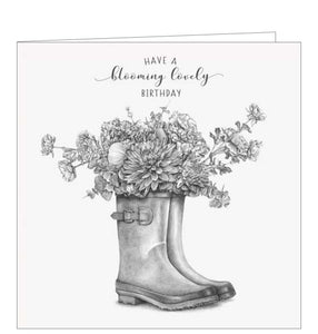 This sweet greetings card from Pigment Production's Life in Pencil card range is decorated with a black and white sketch of a pair of flower-filled wellington boots. The caption on the front of the card reads "Have a blooming lovely birthday".