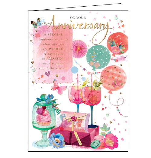 This lovely anniversary card is decorated with a grouping of two cocktail glasses, filled with a delicious-looking drink, and surrounded by presents, balloons and flowers. The text on the front of the card reads 