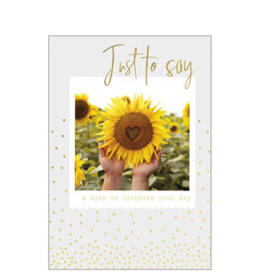 Perfect for&nbsp;many occasions - just to keep in touch, get well, or thinking of you this cheerful card shows a sunflower with a heart shape in the middle. Gold text reads “Just to say".