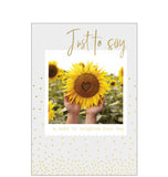 Perfect for&nbsp;many occasions - just to keep in touch, get well, or thinking of you this cheerful card shows a sunflower with a heart shape in the middle. Gold text reads “Just to say".