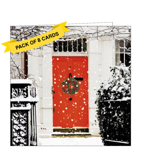 This pack of charity Christmas cards includes 8 cards of one design. The cards are decorated with a photograph of the front of a house, with a wreath hanging from a festive-red front door.
