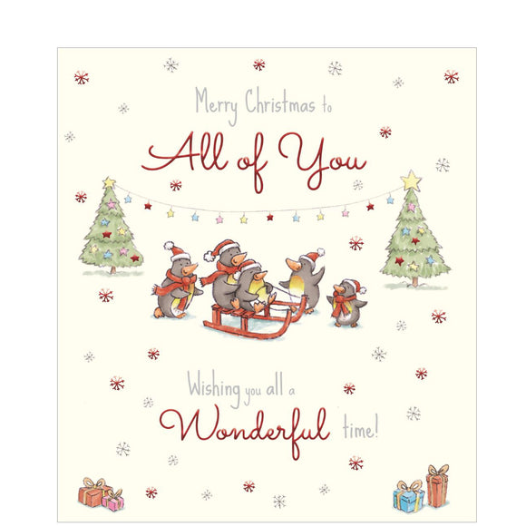 This cute christmas card is decorated with a family of  penguins - in Santa hats and red scarves - playing on a sledge. Stylised  snowflakes in red and silver along with  Christmas trees and bunting add festive decoration. The text on the front of the card reads 