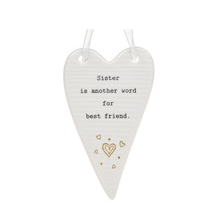 This ceramic plaque from Thoughtful Words Ceramics is an ideal way to express your love and appreciation for your sister. The white glazed heart is decorated with tiny gold hearts beneath stamped black text that reads "Sister is another word for best friend".