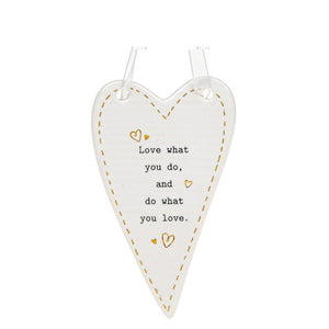 This ceramic plaque from Thoughtful Words Ceramics is an ideal gift for someone setting out on a new job or new venture. The white glazed heart is decorated with tiny gold hearts surrounding black text that reads "Love what you do, and do what you love".