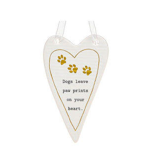 This lovely heart shaped, ceramic plaque from Thoughtful Words Ceramics is the perfect gift for a new dog owner, or someone treasuring a much-loved pup. This white glazed heart is decorated with three tiny gold paw prints above black stamped text that reads "Dogs leave paw prints on your heart".