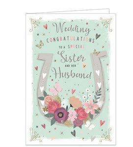 This wedding card for a special sister and brother-in-law is decorated a large white horseshoe, adorned with flowers and butterflies. Silver text on the front of the card reads "Wedding Congratulations to a special Sister and her Husband".