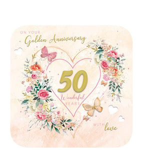 This beautiful golden anniversary card is the perfect way to commemorate fifty years of love. The design features a stunning large decoupage 50 with a heart outline, coupled with floral bouquets and butterflies for a truly special occasion. The light tangerine background provides a subtle contrast to the text on the front which reads, "On your Golden Anniversary...50 wonderful years...with love".