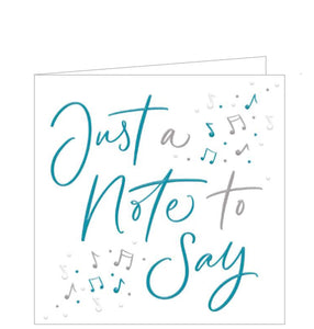 Small white card with electric blue and  silver text that says "Just a note to say". Decorated with blue & silver musical notes in opposing corners. Suitable for any time you wish to  keep in touch