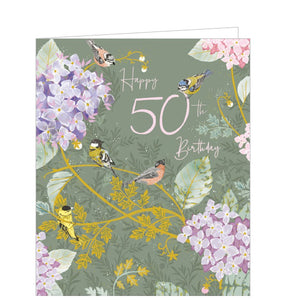 This absolutely gorgeous 50th birthday card is decorated with pink and purple hydrangea flowers blooming on golden branches. Pink text on the front of the card reads "Happy 50th Birthday". Adorable little blue tit birds perch on the branches and text.