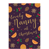 This christmas card for a special nanny is decorated with a scattering of pinecones, stars, holly and slices of orange against a deep purple background. Gold text on the front of the card reads "lovely Nanny at Christmas".