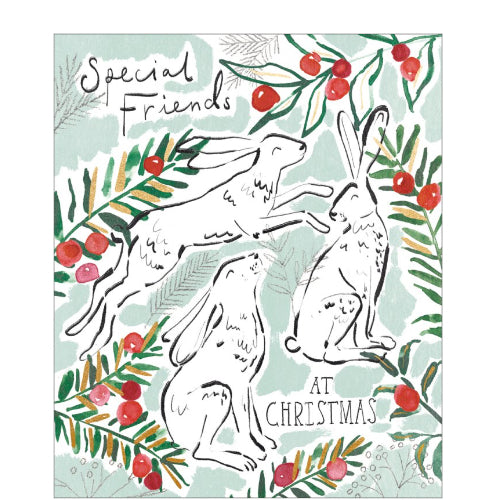 This lovely and unusual christmas card for special friends is decorated with an illustration of three snowy white hares surrounded by winter foliage and red berries. The caption on the front of this Christmas card reads 