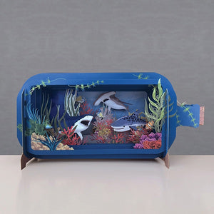 This fabulous pop-up greetings card is made of multiple layers of laser cut card to create a wonderful 3d image, showing different types of shark swimming in the deep. 