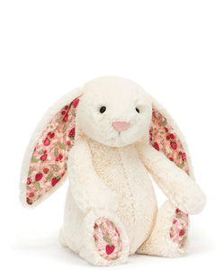 Welcome blossom cream bunny to the Jelly cat garden! Blossom Cream Bunny has been berry picking in the fields. In iconic cream bashful fur, blossom bunny has soft cotton ears and feet, printed with an original Jellycat design of juicy strawberries and cream flowers on a pink backdrop. Bringing the joy of summertime to you all year long!