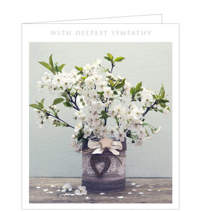 A traditional sympathy card with a photograph of a vase filled with stems of white cherry blossom. The caption on the front of the card reads "With Deepest Sympathy".