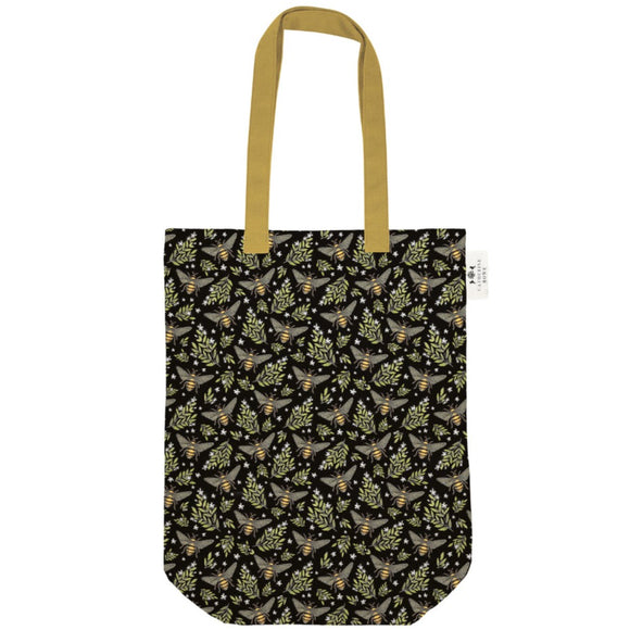 This beautiful tote bag is decorated, front and back, with a repeating pattern of honey bees and flowers on a black background. The bag has contrasting mustard yellow fabric straps and a matching internal pocket.