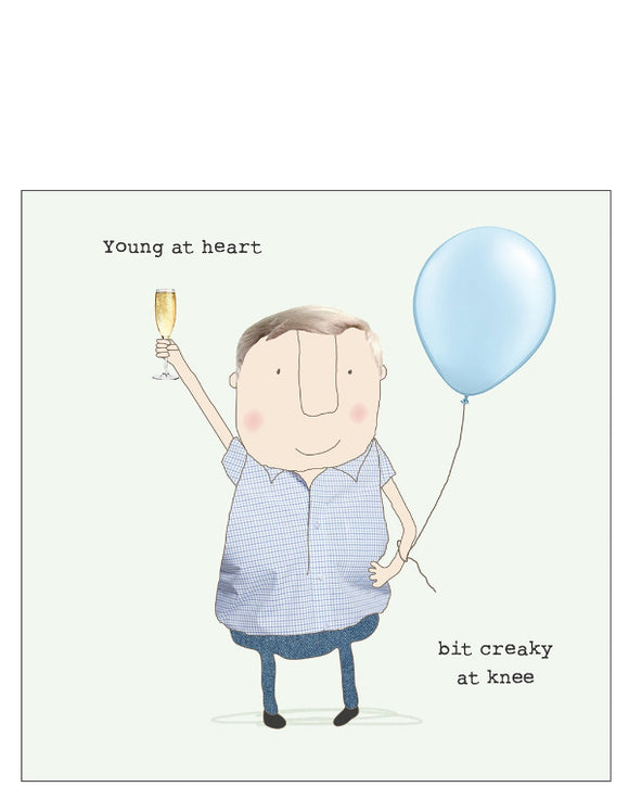 This birthday card features one of Rosie Made a Thing's unmistakably witty and charming illustrations of a man holding a glass of champagne in one hand, and a blue balloon in the other. The text on the front of the card reads 