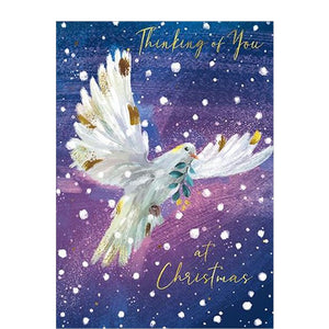 This card is perfect for letting a loved one know they are in your thoughts at a busy time of year. This thinking of you christmas card is decorated with a stunning illustration of a dove flying through a blue and purple sky. The caption on the front of the card reads "Thinking of you at Christmas".