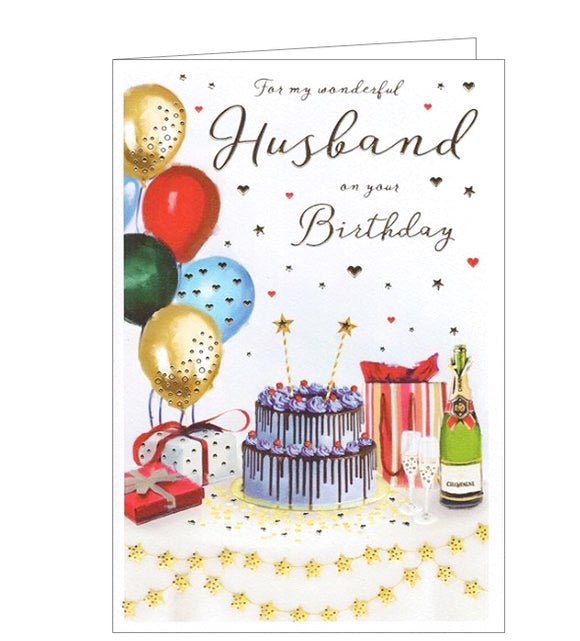 This birthday card for a special husband is decorated with table, all laid for a party, with confetti, star banners and colourful balloons alongside a magnificent birthday cake, gifts and champagne. Gold text on the front of this card reads 