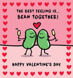 This valentine's card is decorated with a cute illustration of  of Lucilla lavendar's  smiling beans  arm in arm, and champagne in hand. The text on the front of the card reads  "The best feeling is bean together....Happy valentine's Da