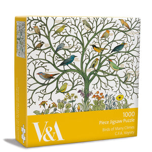 This 1000 piece jigsaw puzzle is decorated with detail from C. F. A. Voysey's (1857-1941) Birds of Many Climes textile design, currently held by the V&A Museum, showing a bare tree with different species of birds perched on the branches. Each bird is labelled, and beneath the tree are beautiful native flowers.