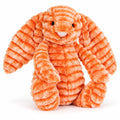 Official Jellycat (jelly cat) independent shop release of a cute and cuddly orange bunny called Fizzleskip for the autumn and winter 2026 season. Image shows a seated Fizzleskip on a white background