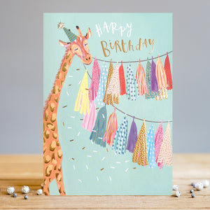 Decorated with a cheerful giraffe, dressed in a party hat, holding up a string of colorful tassels, this Louise Tiler birthday card is sure to put a smile on any kid's face. White and gold text on the front of the card reads "Happy Birthday".