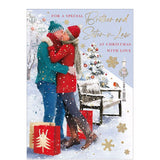 Celebrate the holidays with this beautiful Christmas card for a special brother and sister in law.&nbsp;Featuring a cozy couple kissing in the snow, this card is complete with festive touches, presents, a robin, and Christmas decorations. Share the joy and love with this heartwarming card.