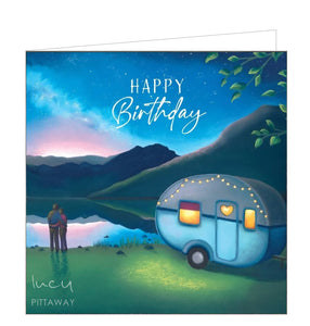 This birthday card features detail from an original pastel drawing by Lucy Pittaway showing a couple standing at a lakeside enjoying a beautiful sunset beside their cosy caravan. The text on the front of the card reads "Happy Birthday".