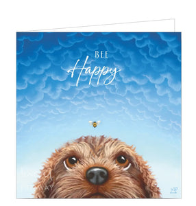 This lovely blank greetings card features detail from an original pastel artwork by Lucy Pittaway showing the top half of a dog's head as he watches a bee that could be about to land on his nose! A lovely blue sky is behind him, with the words "Bee Happy" in white script.