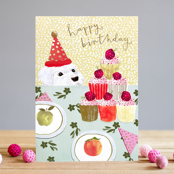 This fun and bright Louise Tiler birthday card features a white pup in a festive party hat, looking longingly at an arrangement of colourful pupcakes. Its bold and vibrant design will bring a smile to the special birthday boy or girl! Gold text on the front of the card reads 