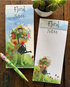 Stay organised in the sweetest way with this beautifully designed magnetic listpad by Alex Clark, featuring detail from an artwork showing a gardener - in wellies, straw hat and gardening gloves - hidden behind a trug of flowers and flower pots. The caption on the front of the listpad reads "Floral Notes".
