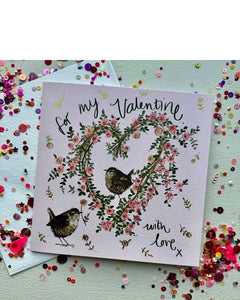 A romantic, cute Valentine's card featuring Alex Clark's illustration of two wren birds perched on a heart-shaped wreath.&nbsp; The colouring is beautiful in browns and pinks with gold details. Black script on the front of the card reads "for my valentine, with love X".