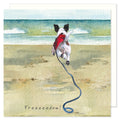 Funny and cute greetings card showing a jack russell terrier dog bounding across a beach in a red coat