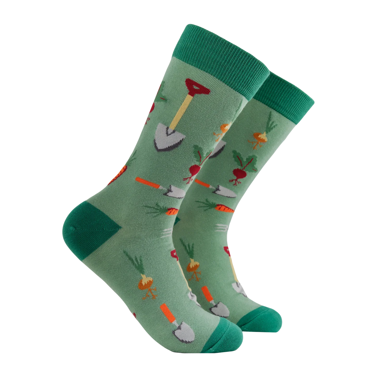 A pair of sage green adult crew socks from Socktopus with a garden-themed pattern featuring carrots, radishes, and trowels, displayed on a clean white background.