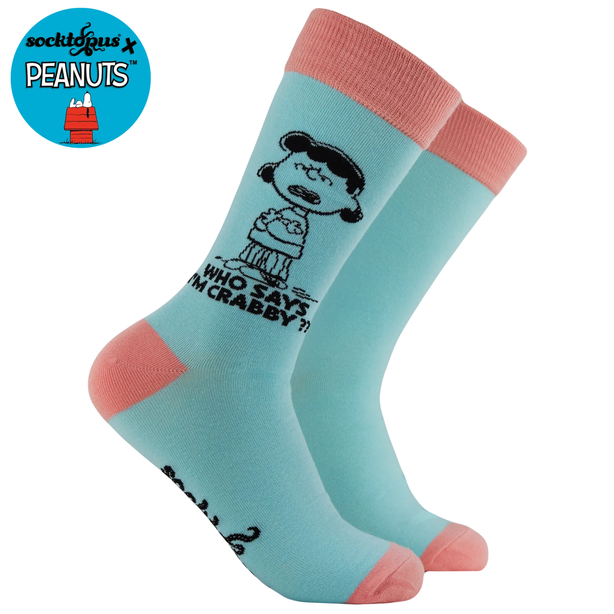 Light blue socks with pink accents featuring a character from Peanuts,saying “who says I’m crabby,”