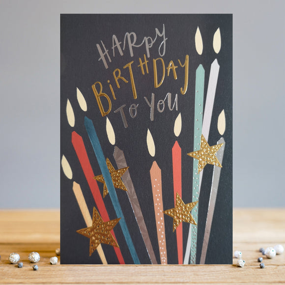 Celebrate a special day with this stylish and eye-catching Louise Tiler birthday card. Featuring bright candles and bold gold stars on a classy matt black background, this card is sure to brighten up the festivities. Text on the front of the card reads 