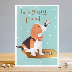 Send a special message to a special friend, whatever the occasion. This beautiful Louise Tiler greetings card is decorated with a cute beagle dog with a butterfly on its nose. The adorable pup is sitting on a golden welcome mat in front of a mint green and white polka dot background. The caption on the front of the card reads "To a Special Friend".